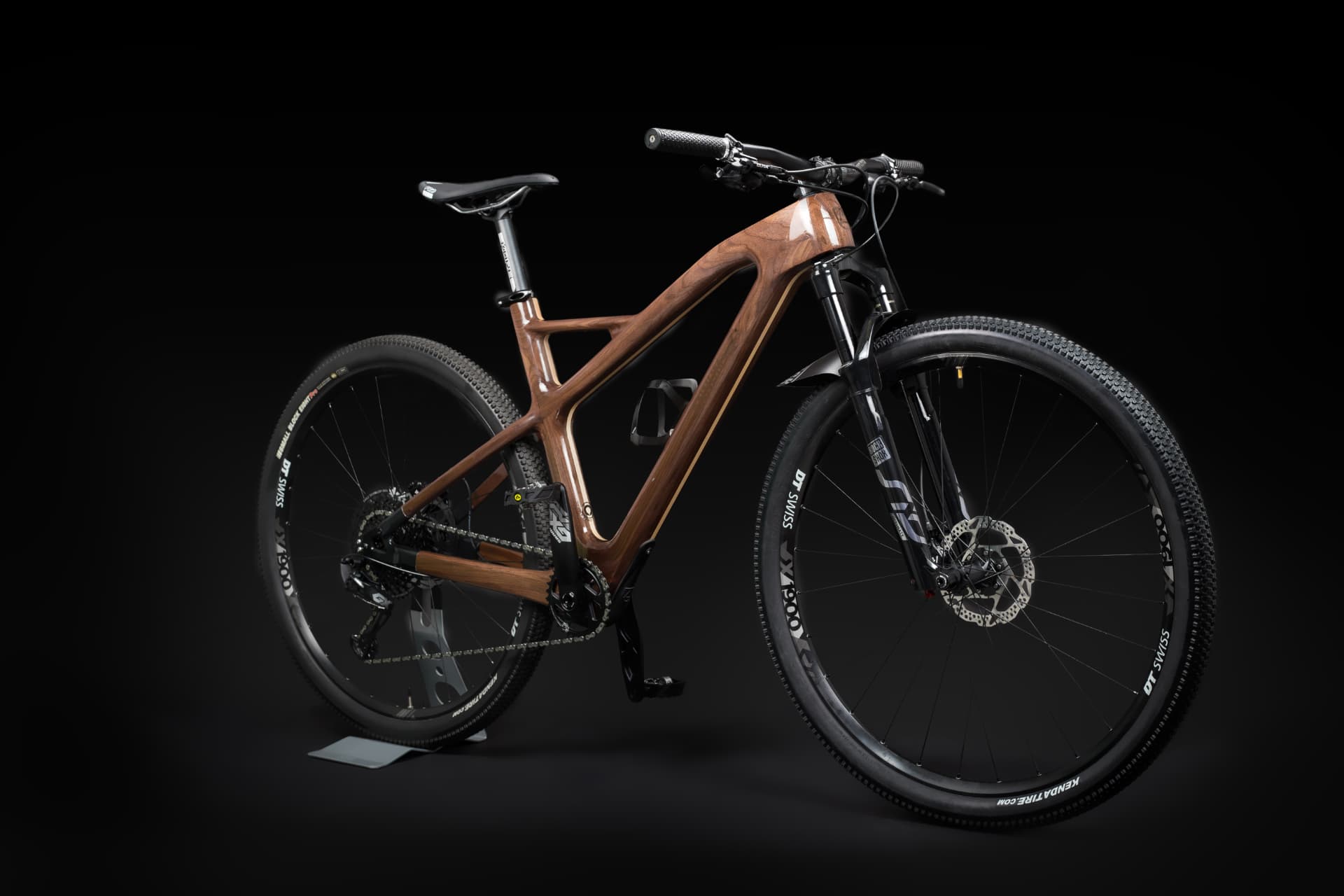 Handcrafted Annum wooden mountain bicycle photographed against a black background