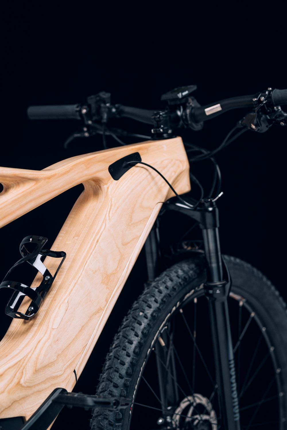 Wooden frame and handlebar detail of an Annum bicycle