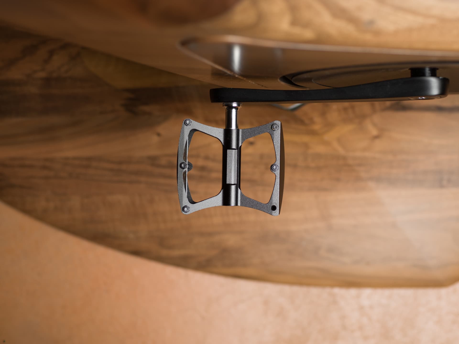 Pedal and crank detail of the handcrafted wooden exercise bike