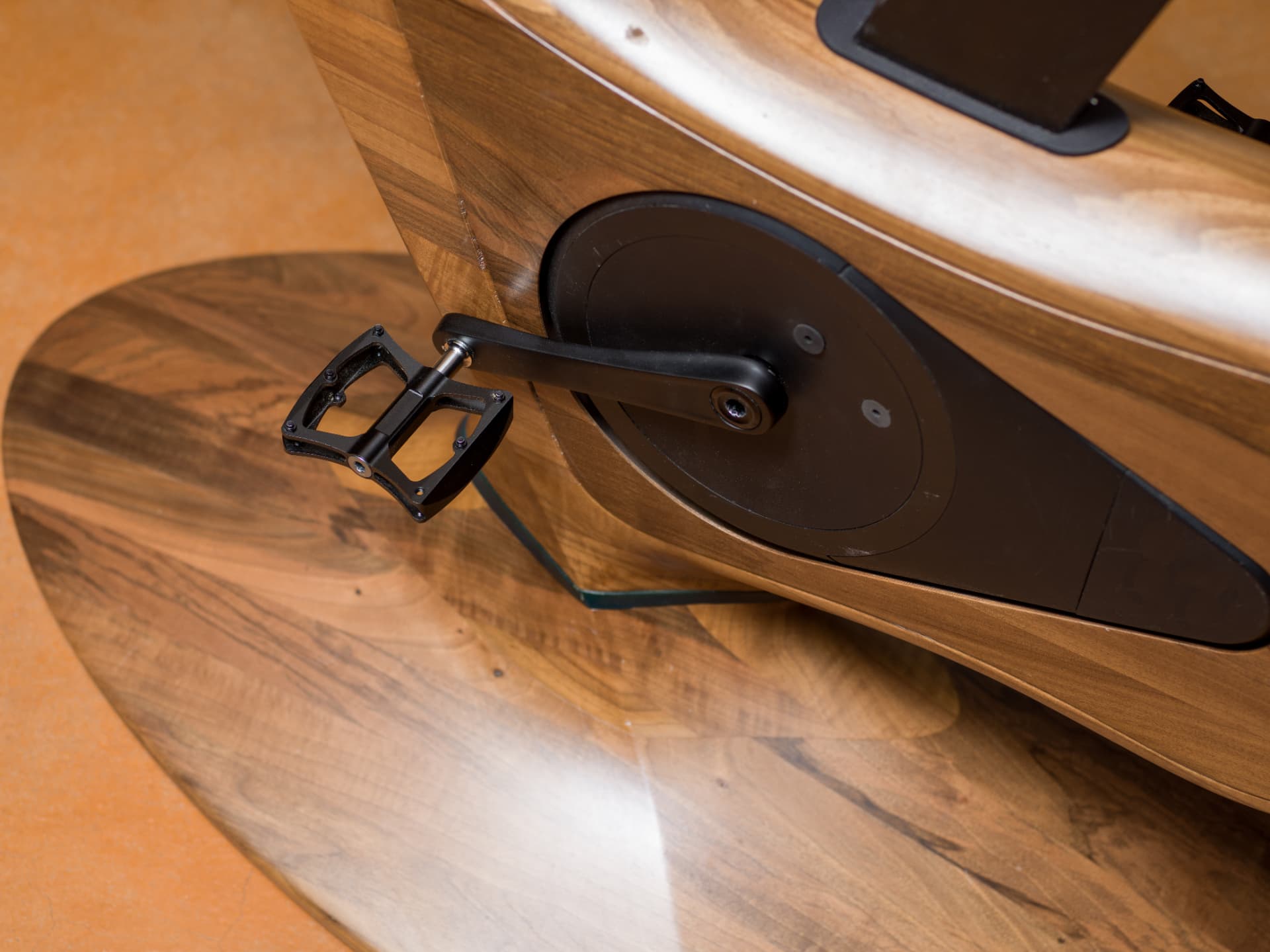 Crank, flywheel cover and wooden body detail of the Annum indoor bike