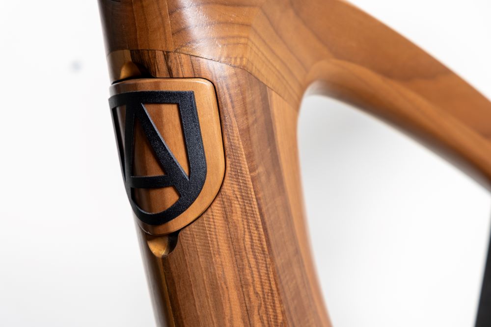 Annum emblem inlaid into the wooden frame of the indoor bike