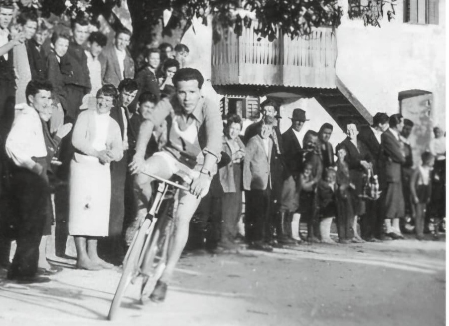 Historical photograph of a village bicycle race in Cerkno, Slovenia, part of the Annum family heritage