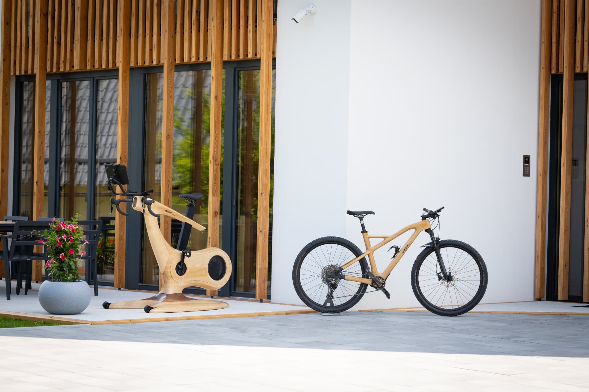 Handmade Annum wooden indoor bike and wooden mountain bike on a contemporary terrace